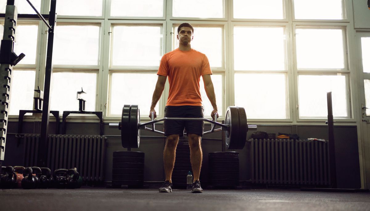 Man performs trap-bar deadlift