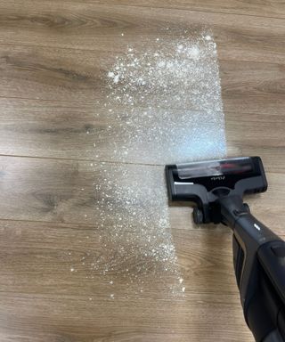 Miele Triflex HX2 Pro vacuuming flour and sugar on wooden floor in Future test center