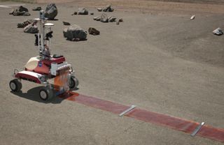 NASA's K10 rover at the Ames Research Center in Moffett Field,Calif., performs a surface survey with its cameras and laser system, and then deployed a simulated polymide antenna while being controlled by an astronaut in space during a June 2013 test.