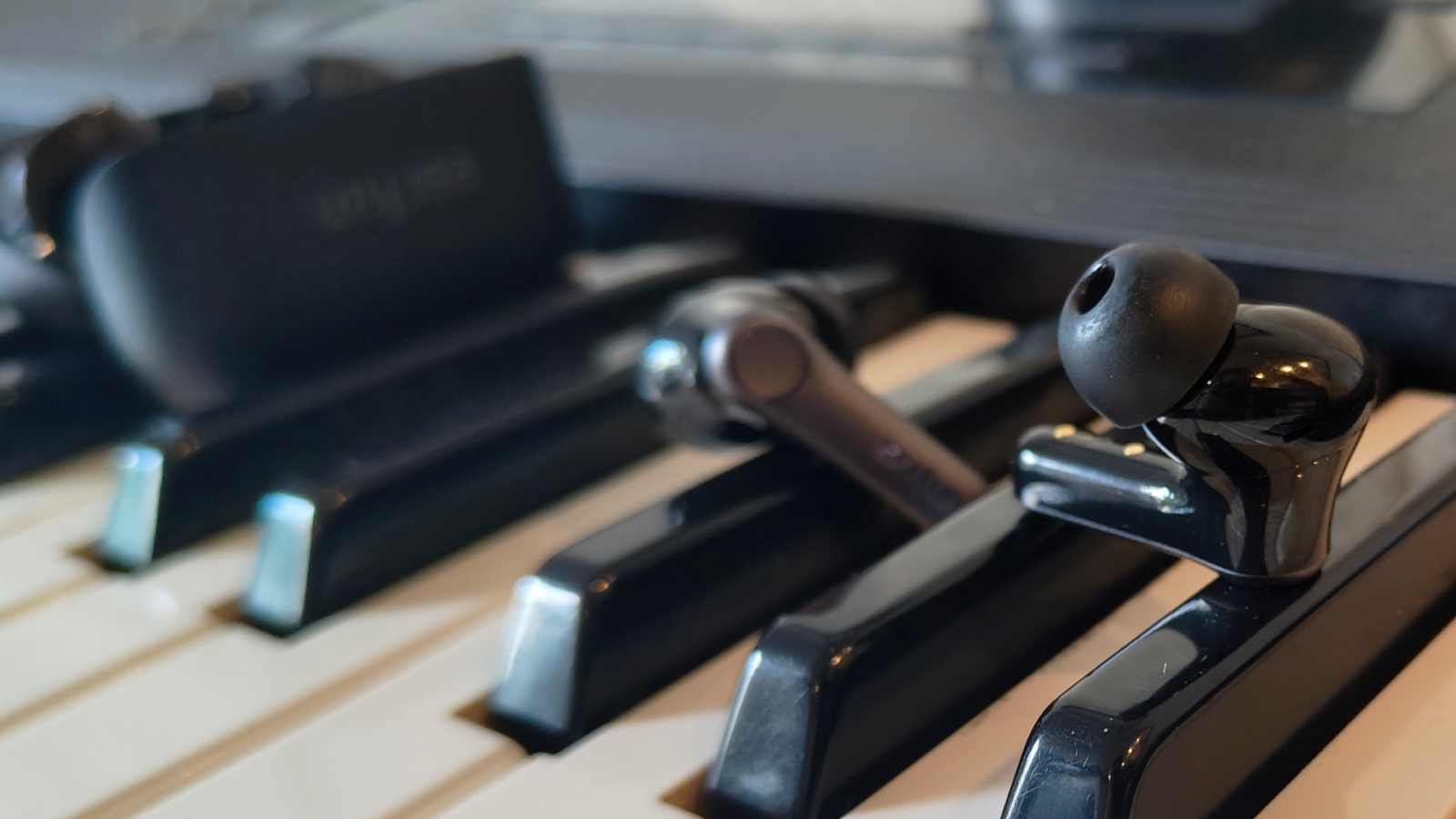 The Earfun Air Pro 4 Plus on top of a keyboard.