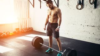 Man standing over barbell during workout