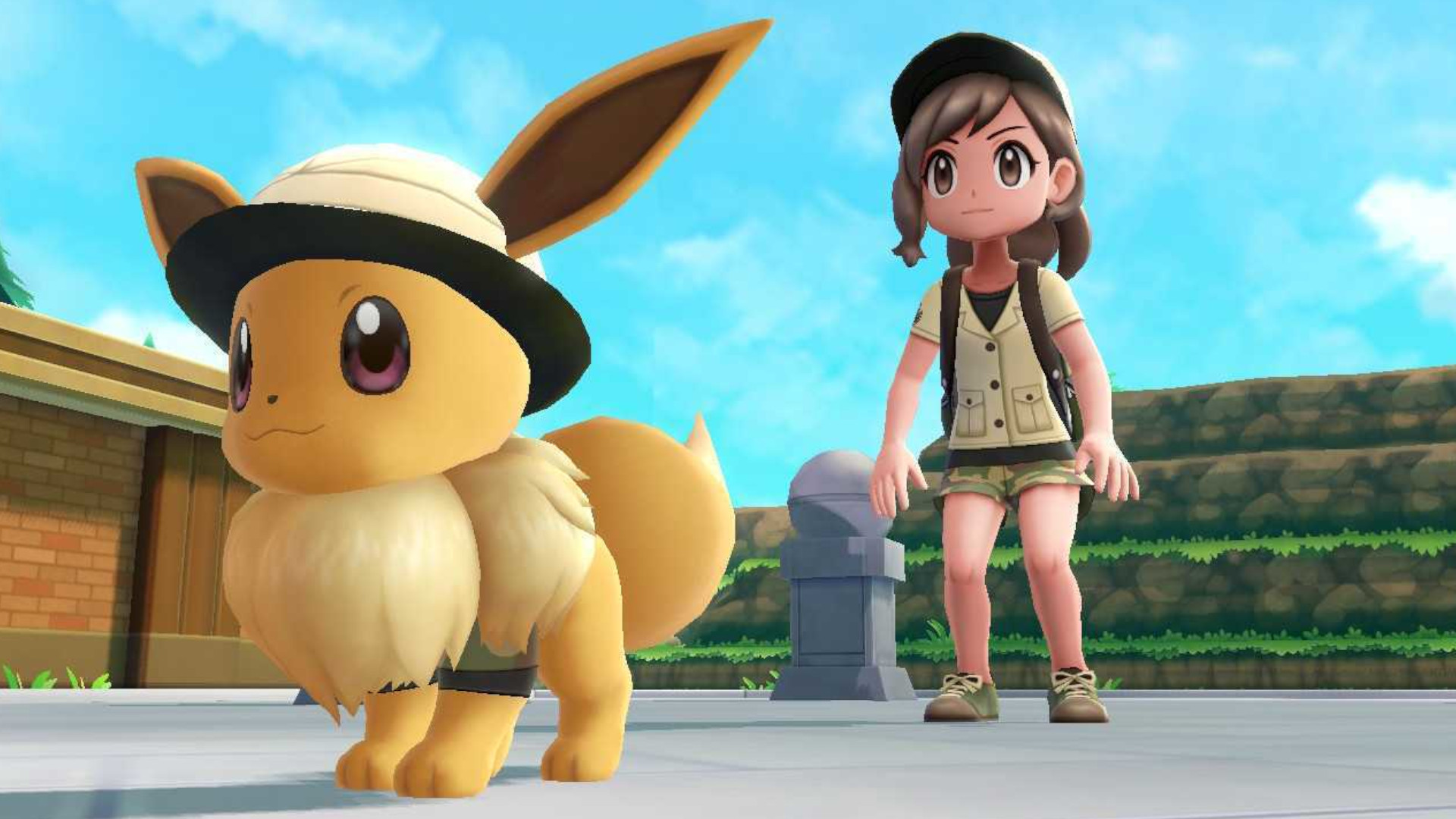 A trainer and an Eevee wearing matching safari outfits before a battle during the family-friendly RPG, Pokemon: Let's Go, Pikachu! and Let's Go, Eevee!
