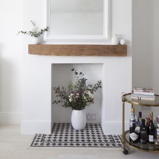 white fireplace with black and white tile hearth