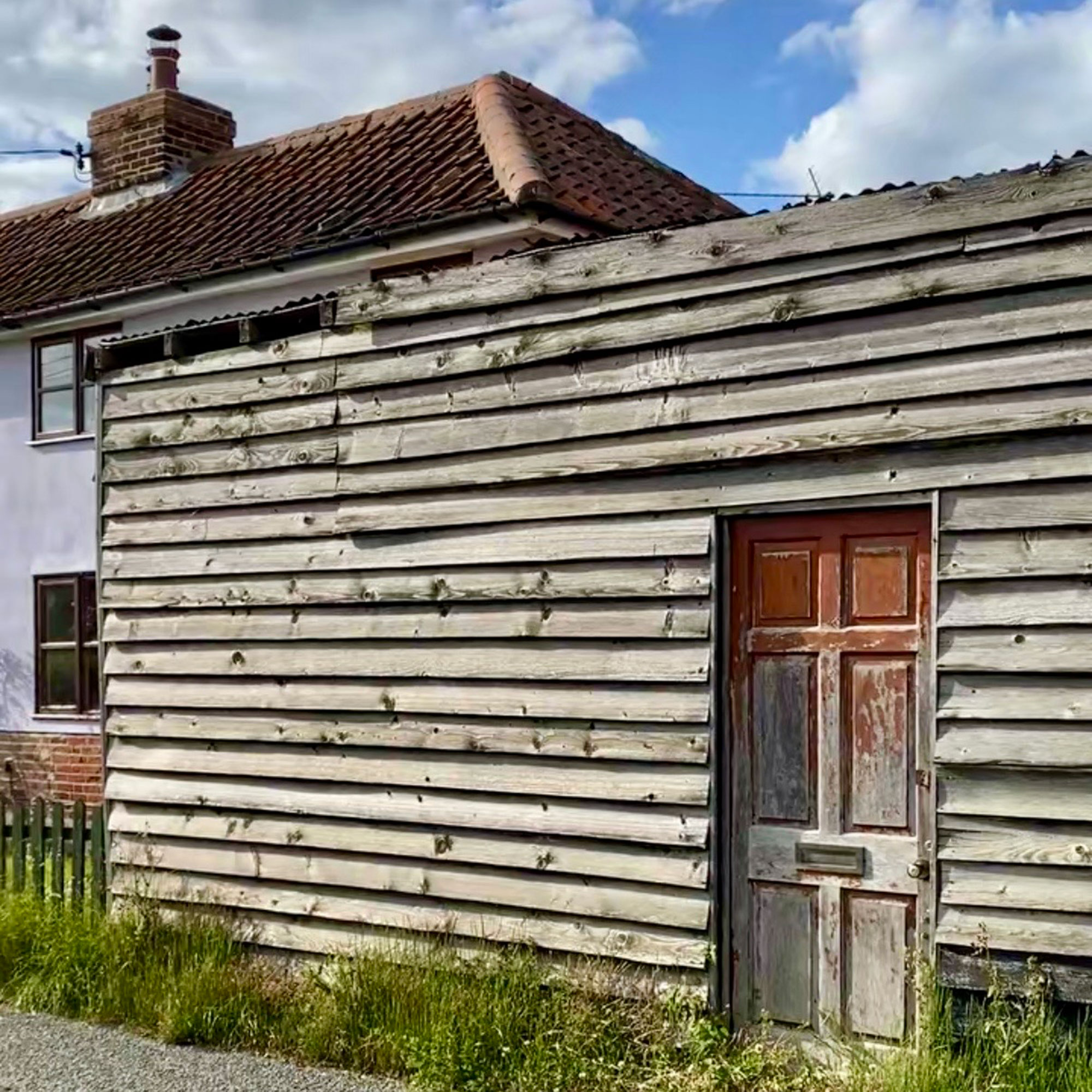 Wooden outbuilding beside house