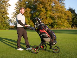 The Motocaddy Cube Push Cart being pushed