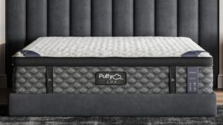 Puffy Lux Hybrid mattress on a greyt carpet against a grey wall