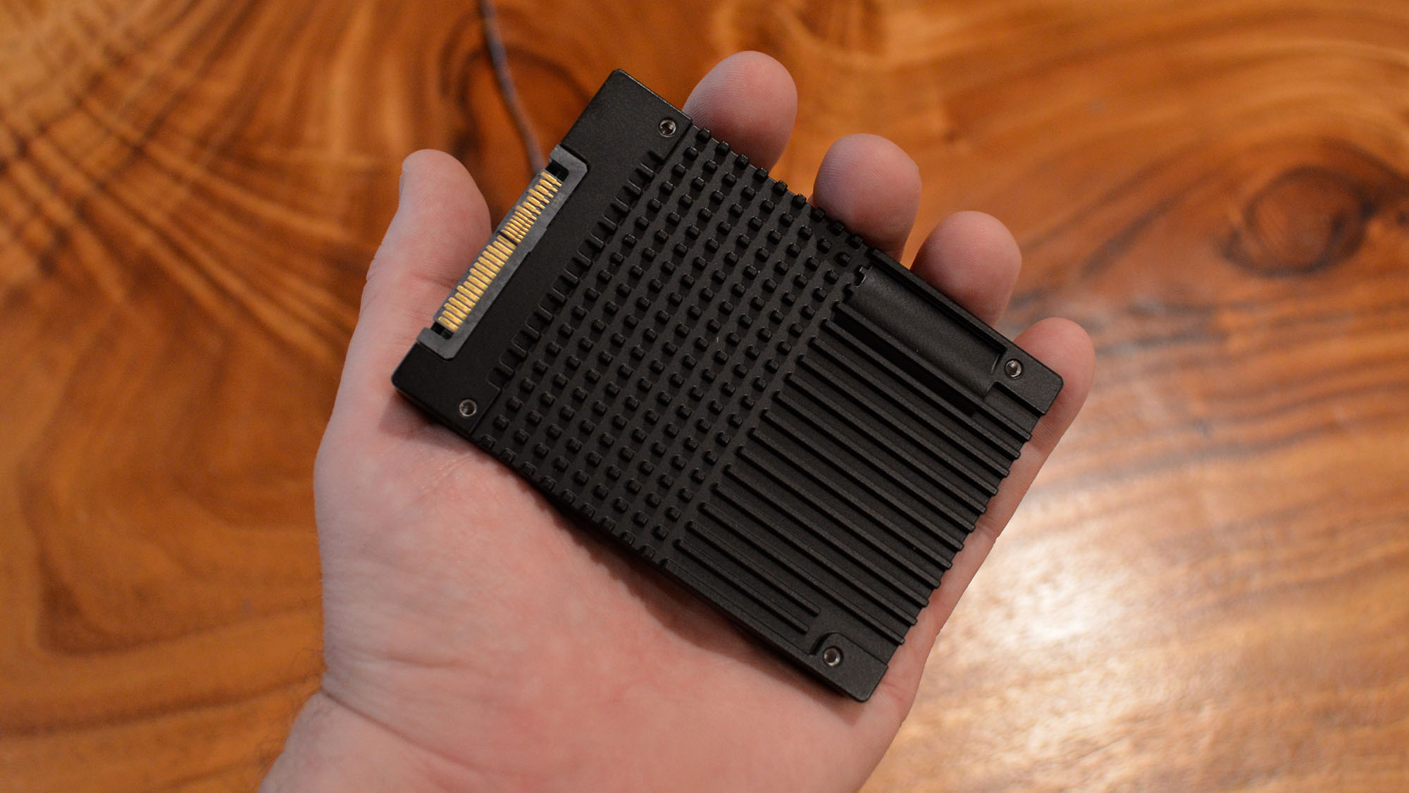 A FlumeIO 5900-series SSD in a masculine hand