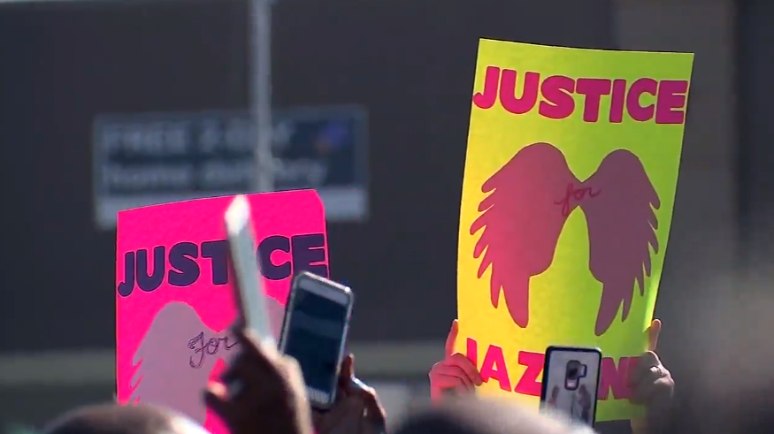 Signs at a vigil for Jazmine Barnes