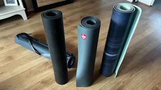 Best yoga mats pictured together against wooden floor