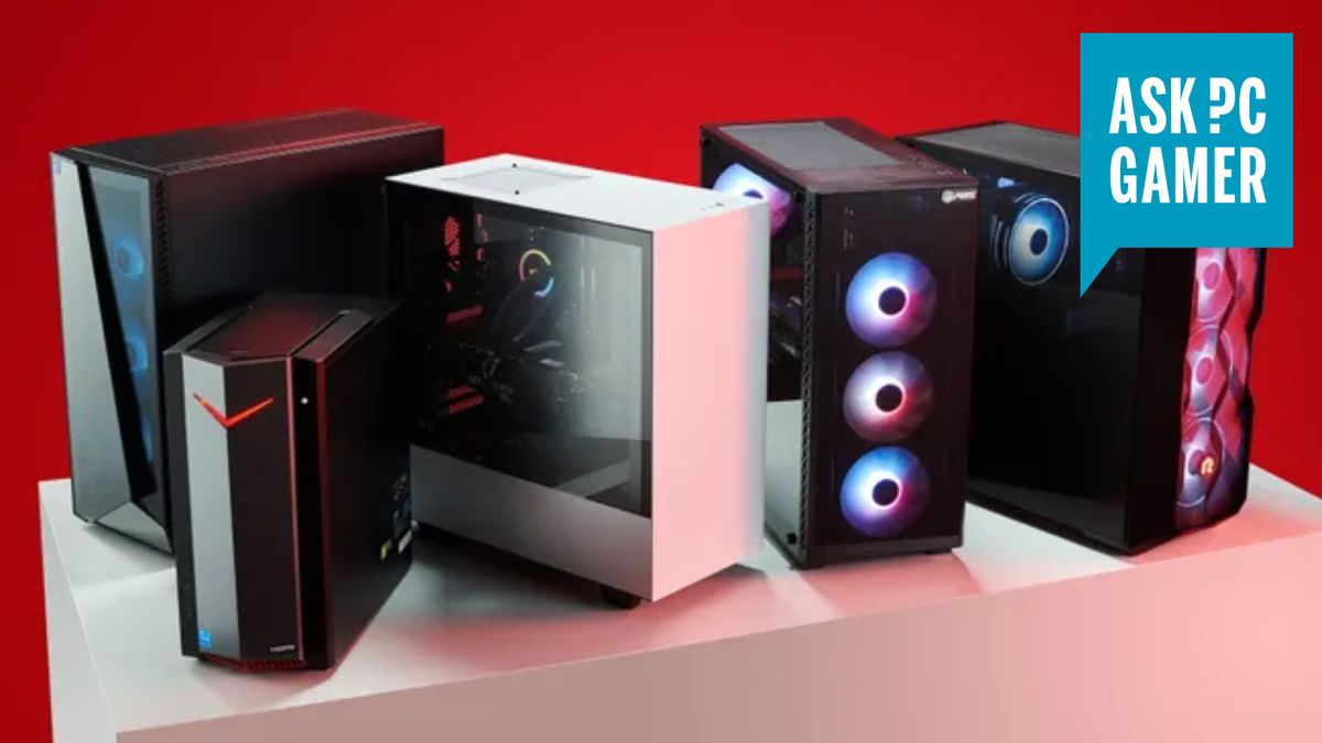 Several gaming PCs on a table in front of a red background, with an &quot;ask PC Gamer&quot; logo in the top right corner