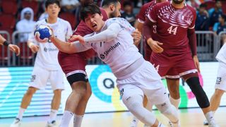 South Korea's Park Seung getting tackled in a qualifier match for the Olympic handball tournament.