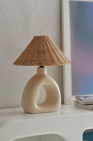 rattan and stoneware lamp on a tabletop