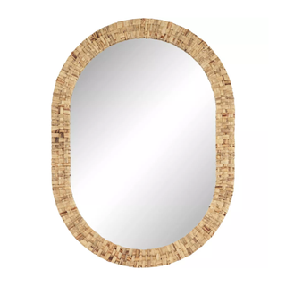 An oval vanity mirror with rattan binding