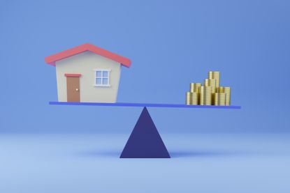 A house balanced against a pile of money on a scale