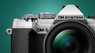 The OM System OM-5 camera on a green background