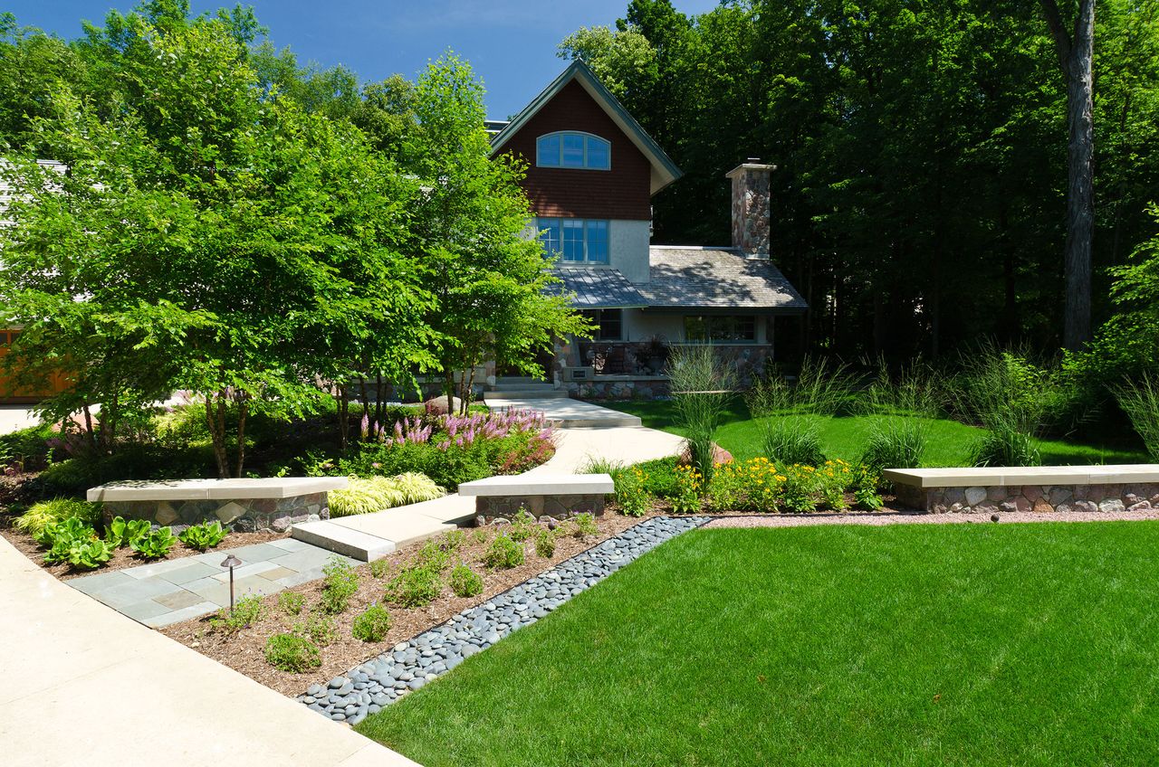 Green lawn in front yard with trees