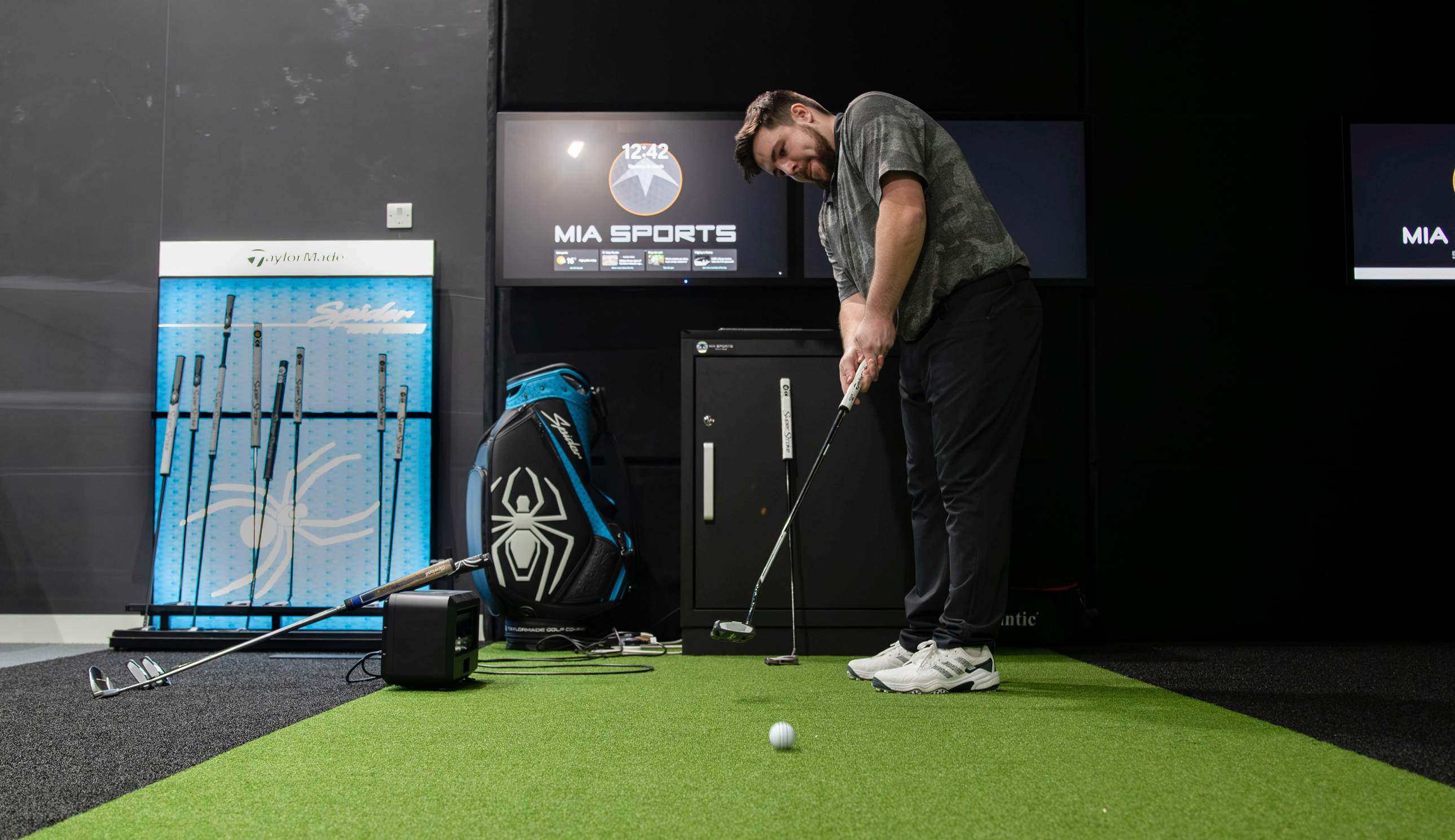 A golfer hits a ball with a putter