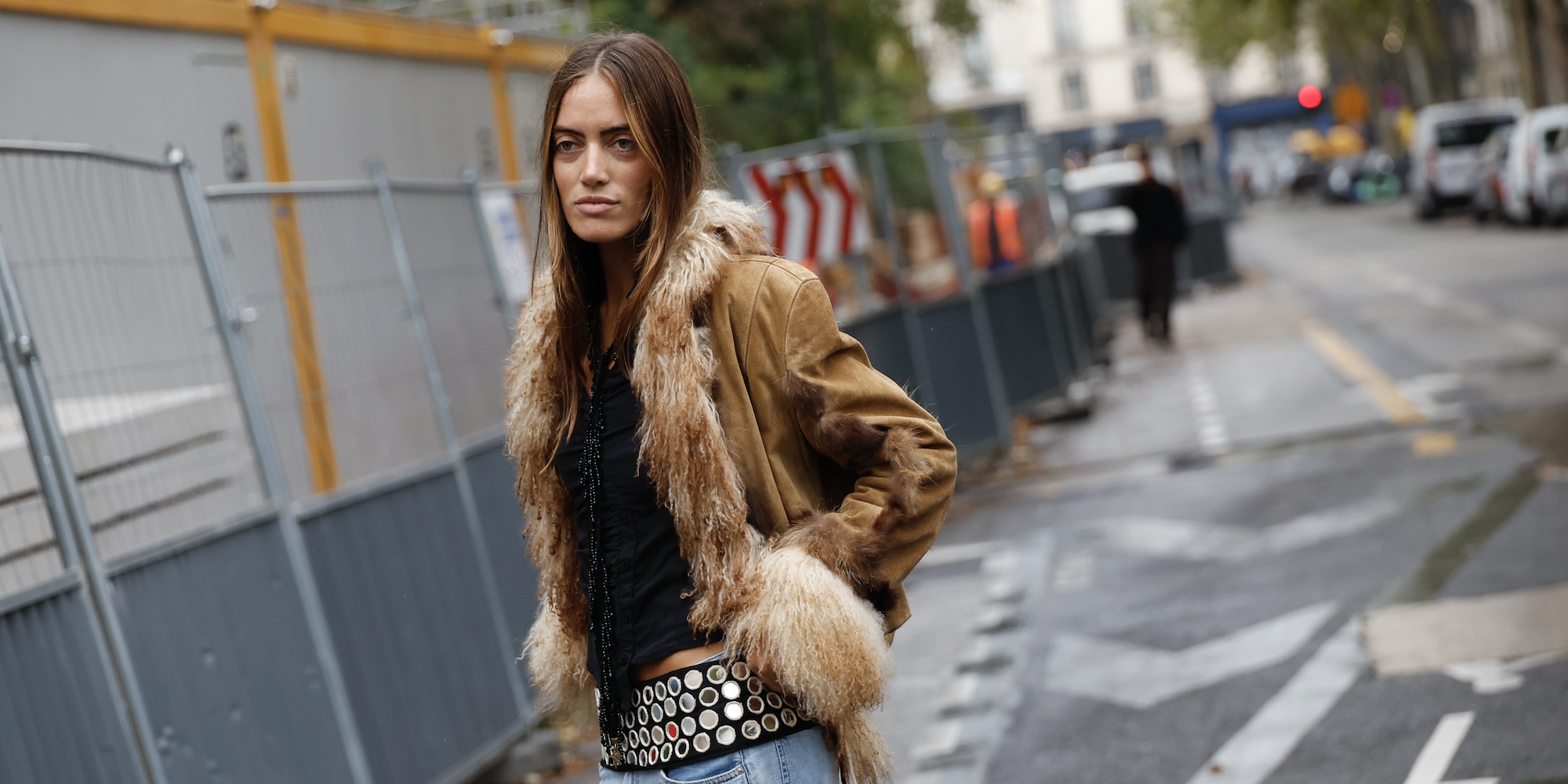 woman wearing a fur coat and a thick metallic belt