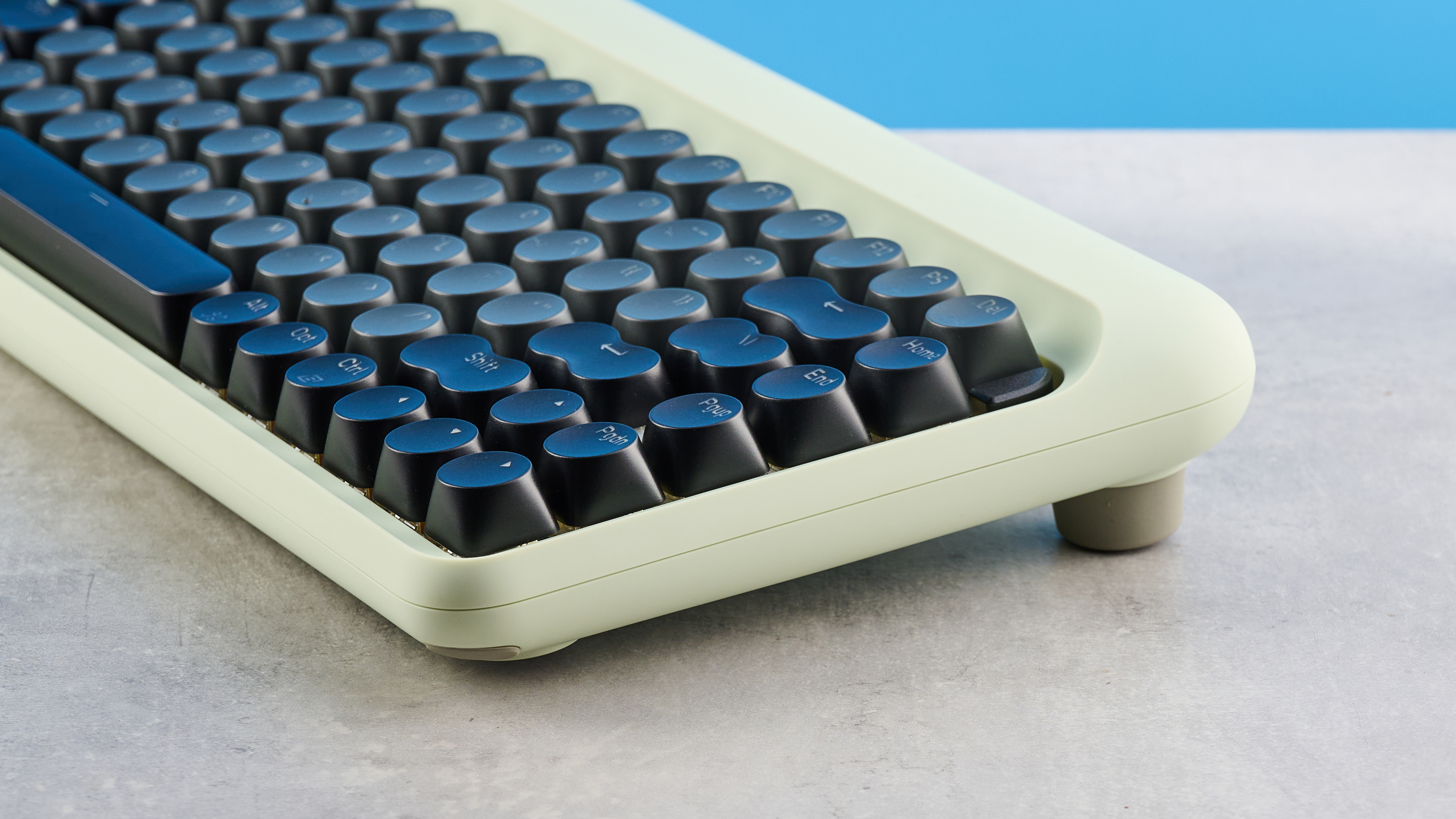 The Lofree DOT on a stone surface, the image shows the keyboard&#039;s side profile