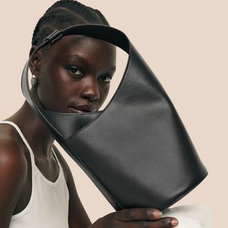 Flat lay image of woman with a black bag 