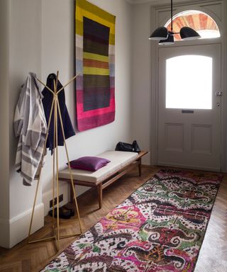 Narrow hall ideas with pink and purple patterned runner and artwork.