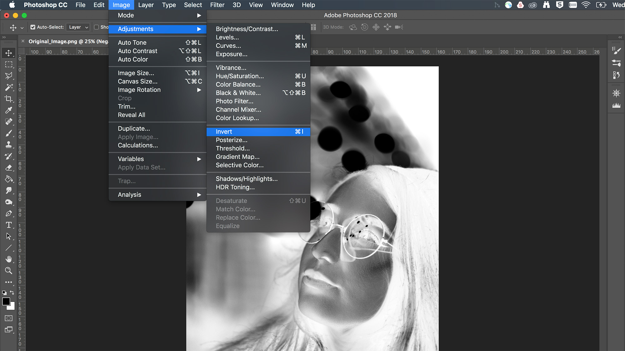 Adobe Photoshop screenshot showing how to invert a layer to create a negative of the portrait image shown