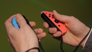 Nintendo Joy-Con controllers in hands