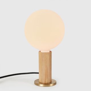 Tala Knuckle Table Lamp against a gray background.