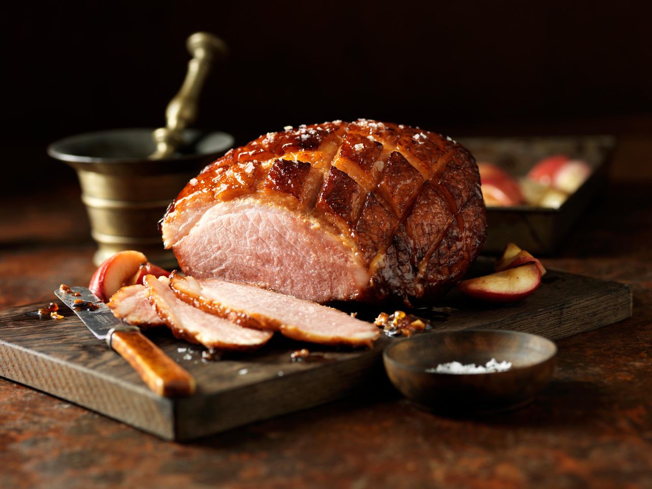 carved roast bacon joint on a wooden board