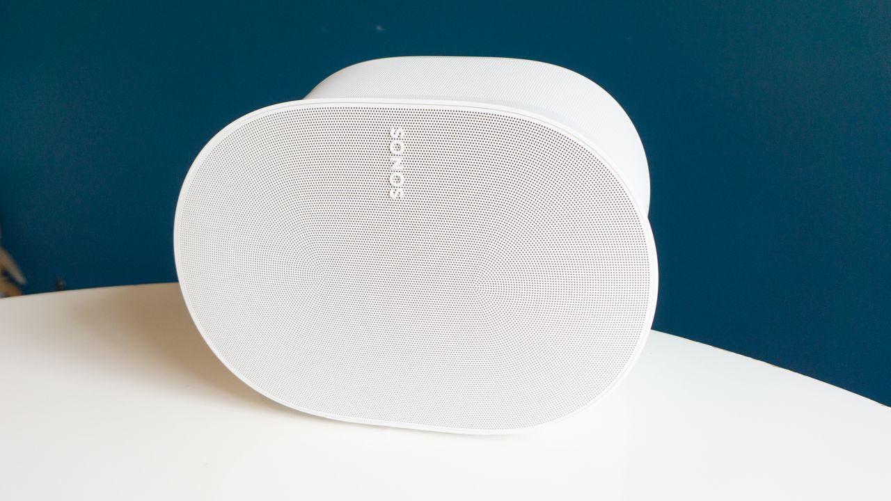 The Sonos Era 300 on white table at a slight angle. We can see its front grille texture clearly, and the Sonos logo.