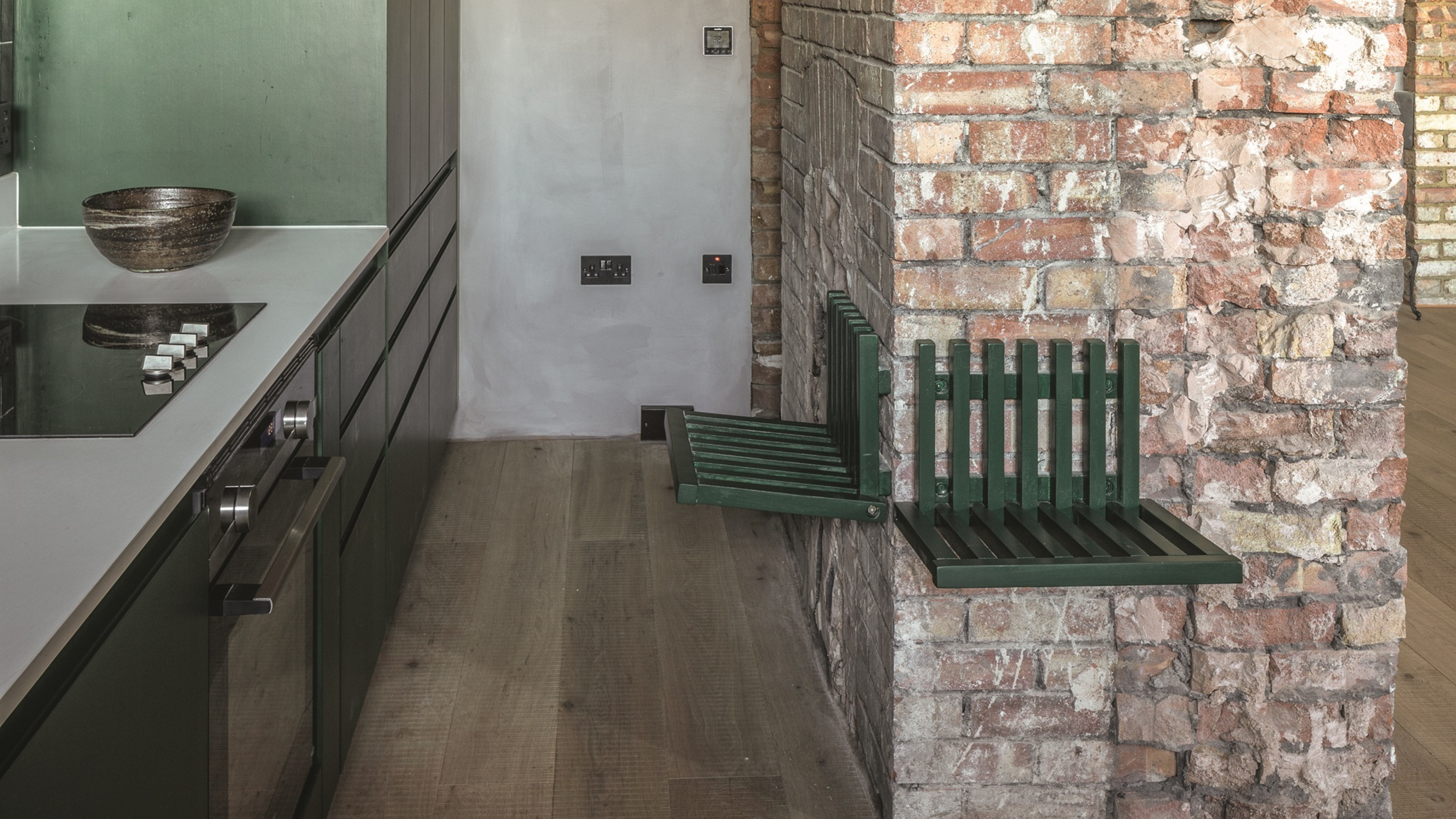 Cupboards by Puustelli, painted moss green (Ral). Quartz worktop by Silestone. Bespoke fold-down bench by Inter Urban Studios, painted moss green (Ral). GE fan table lamp. 