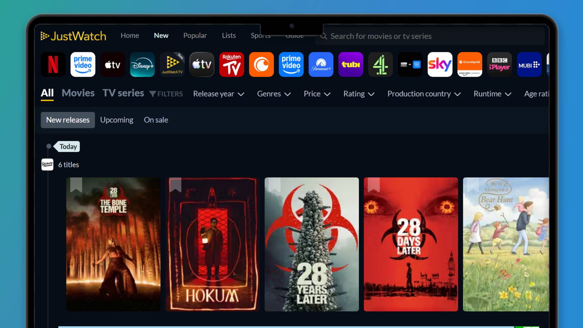 A laptop screen with the JustWatch home page