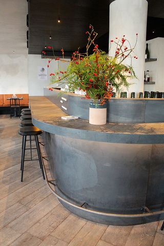 Bar counter with flower vase and bar stools