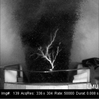 Volcano lightning created in laboratory experiment at Ludwig Maximilian University of Munich. The spark is a few inches in length.