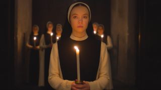 Sydney Sweeney in Immaculate holding a candle. 