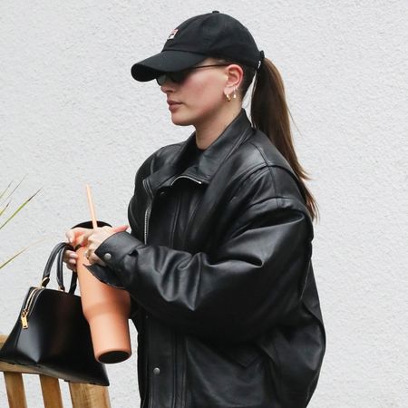 Hailey Bieber wearing a leather bomber jacket