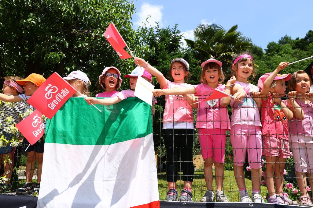 SANTUARIO DI CASTELMONTE ITALY MAY 27 A group of kids wait for the peloton to pass during the 105th Giro dItalia 2022 Stage 19 a 178km stage from Marano Lagunare to Santuario di Castelmonte 577m Giro WorldTour on May 27 2022 in Santuario di Castelmonte Italy Photo by Michael SteeleGetty Images