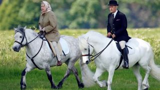 Queen Elizabeth II, accompanied by her Stud Groom Terry Pendry, seen horse riding in the grounds of Windsor Castle
