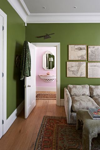 Green bedroom with pink hallway beyond