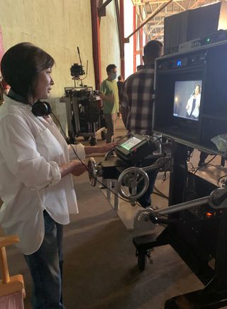 Shannen Doherty looking at a camera on set
