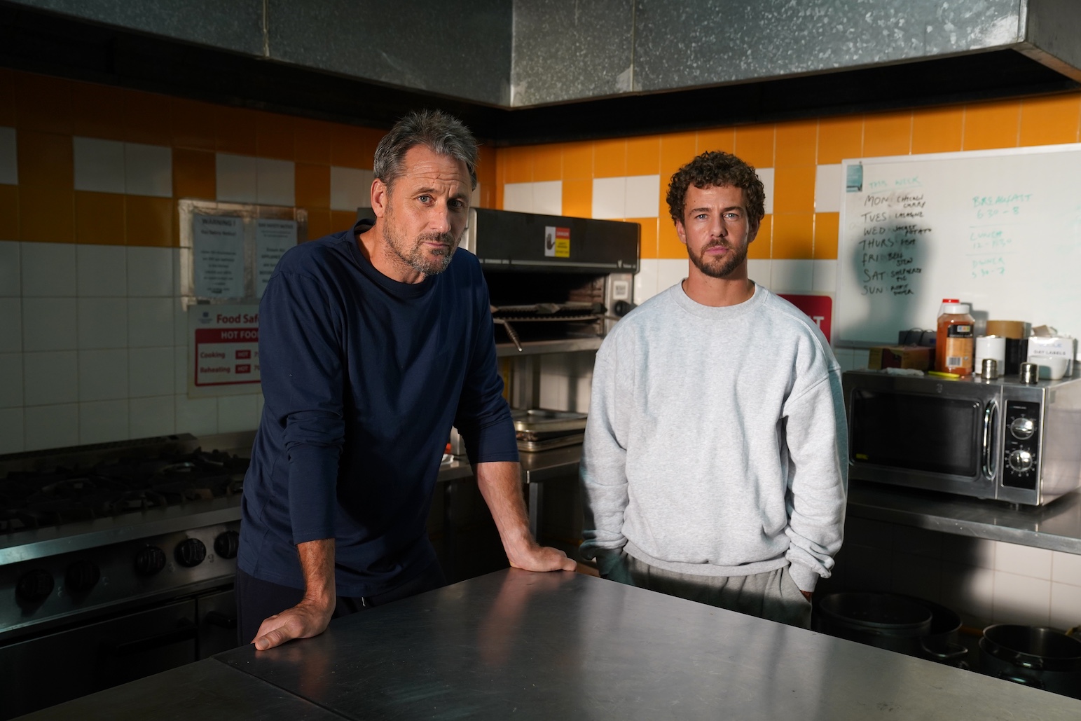 Joel Dexter standing with his prison inmate Tony Hutchinson.