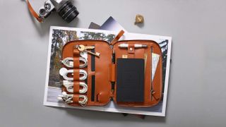 Nomad organizers Mini, one of the best tech organizers, on a desk next to camera