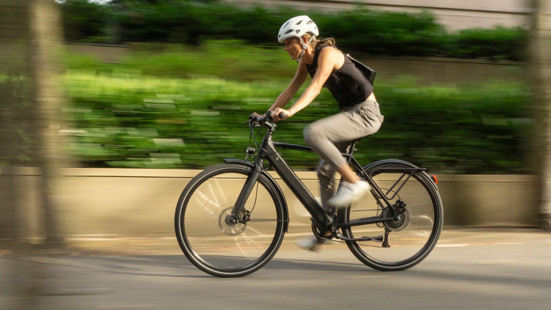 Woman cycling through forest
