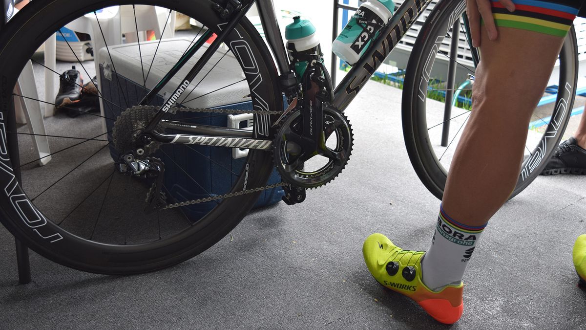 The world champion checks out his bike ahead of a training ride