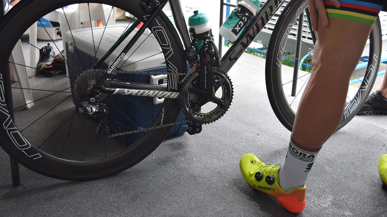 The world champion checks out his bike ahead of a training ride