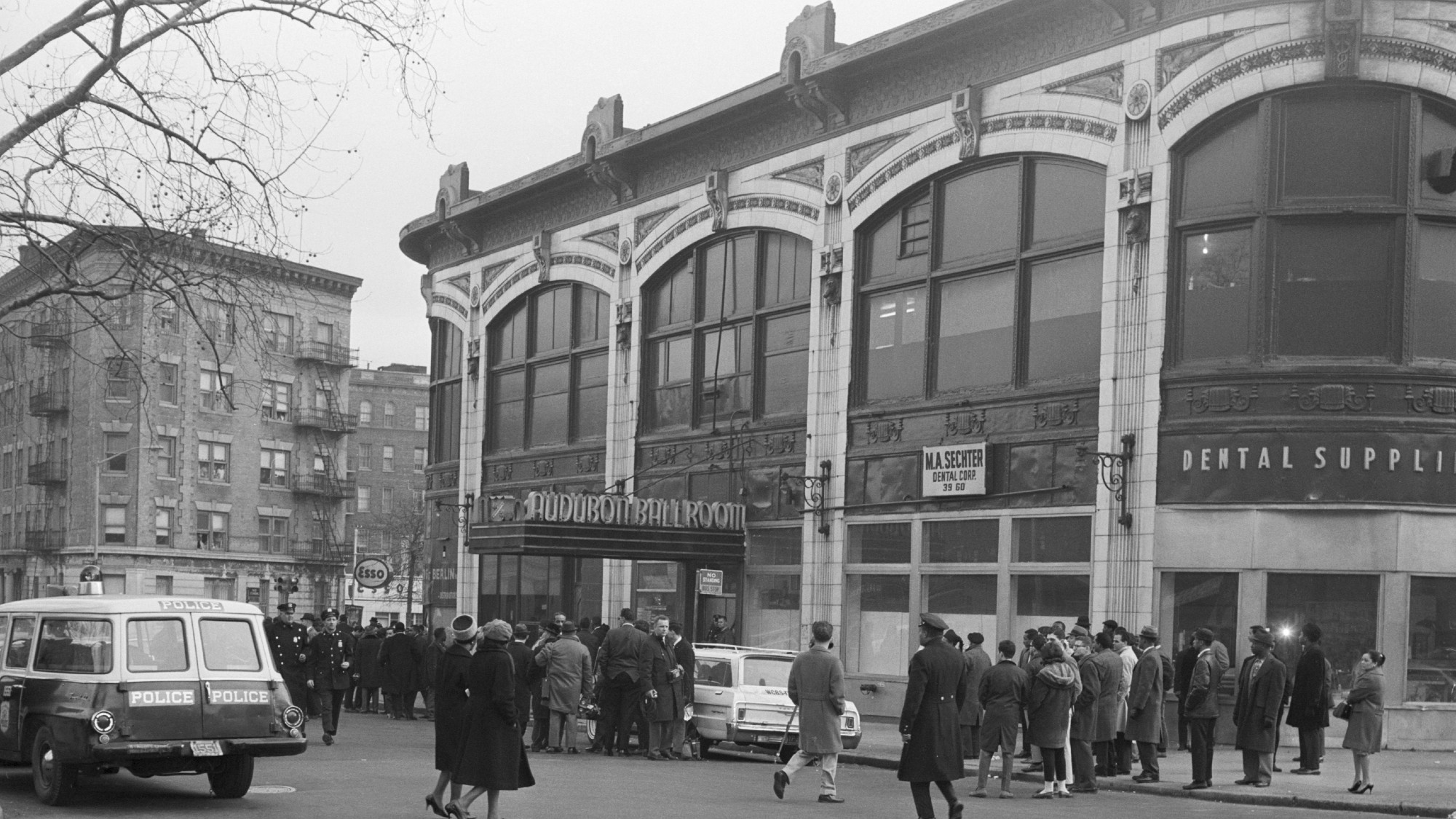 Black and white photograph of a crowd of people outside the Audubon ballroom, New York City