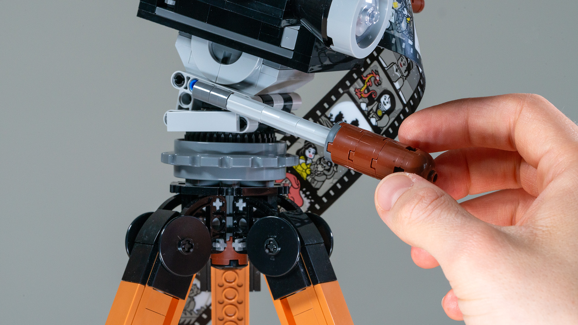 Lego Walt Disney Tribute Camera (43230) close up of hand holding the tripod head arm