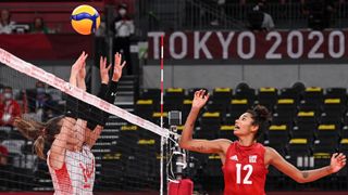 USA's Jordan Thompson (R) hits the ball in the women's preliminary round pool B volleyball match between USA and Turkey during the Tokyo 2020 Olympic Games at Ariake Arena in Tokyo on July 29, 2021.