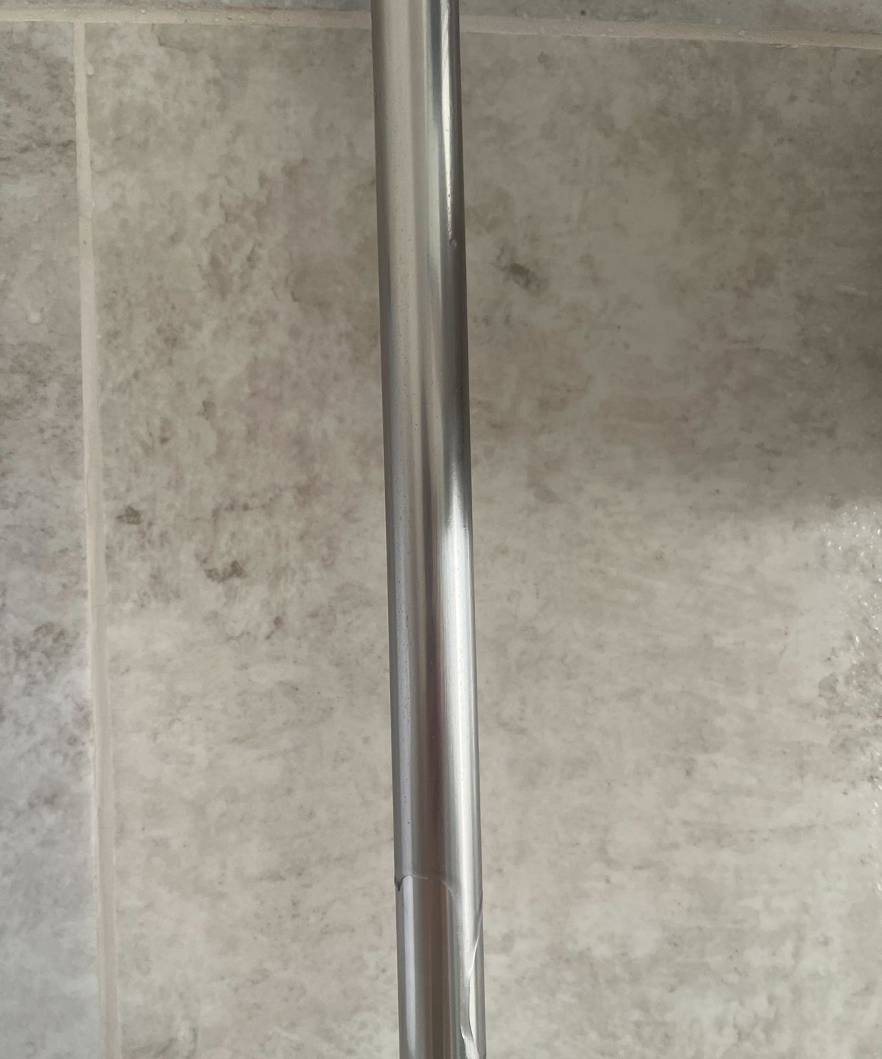 The metal bar that holds a shower head with no water marks