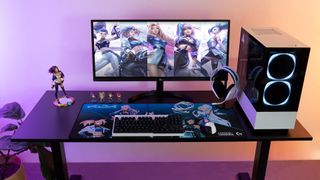 K/DA gaming gear on a gaming PC setup with RGB lighting